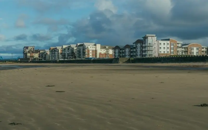 Ayr beach at low tide with seafront apartments