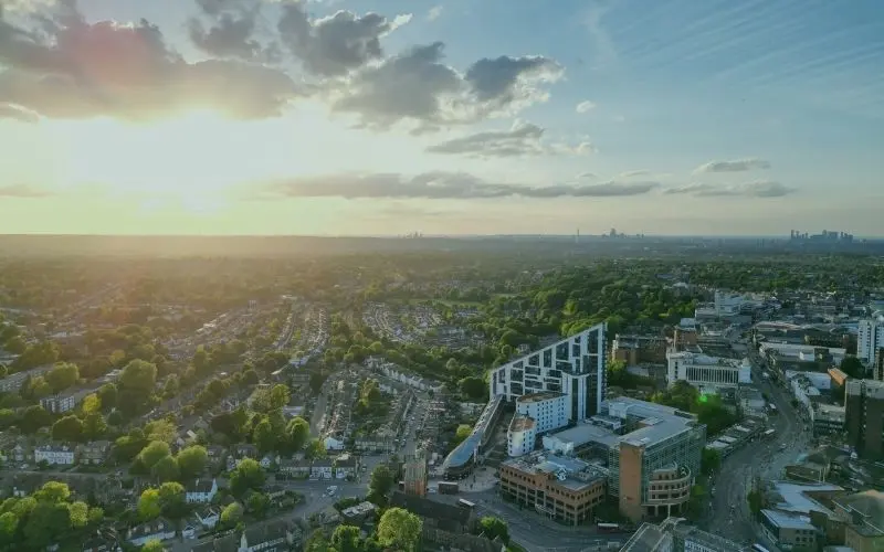 Bromley town centre from above at sunset, with the London skyline on the horizon