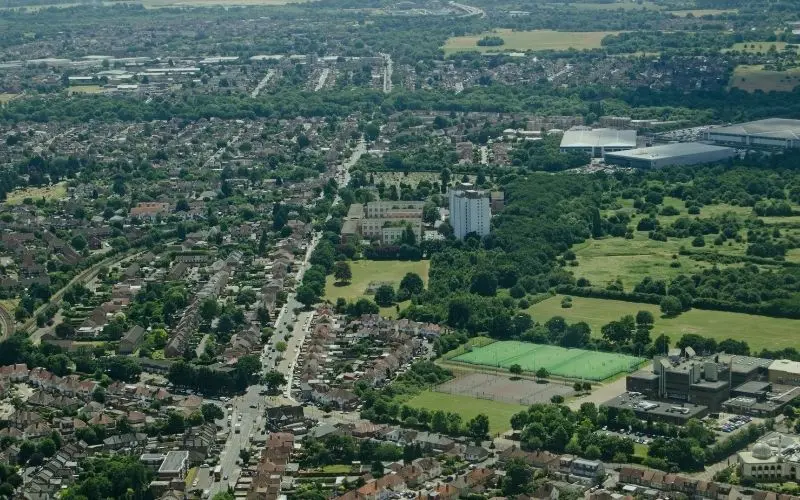 Aerial view over Hounslow's streets, playing fields and warehouses