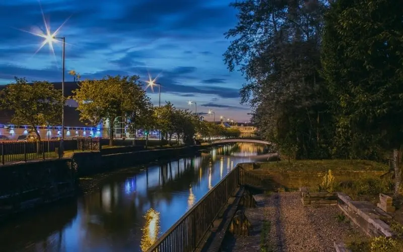 Newry Canal at dusk with the town lights reflected in the water