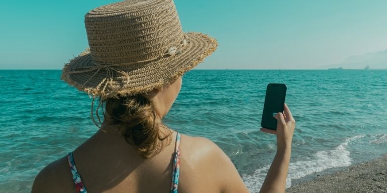 Traveller checking their phone at an airport