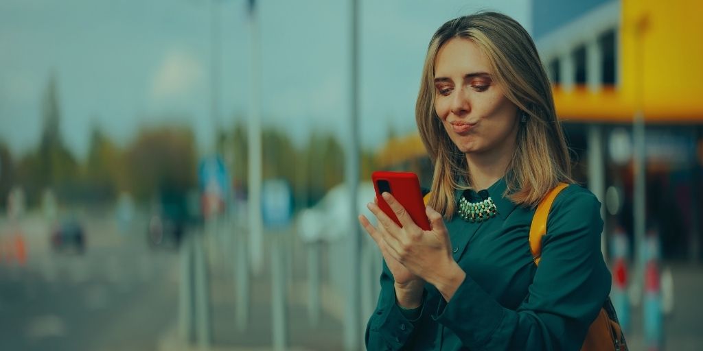 Woman checking mobile signal on her phone outdoors