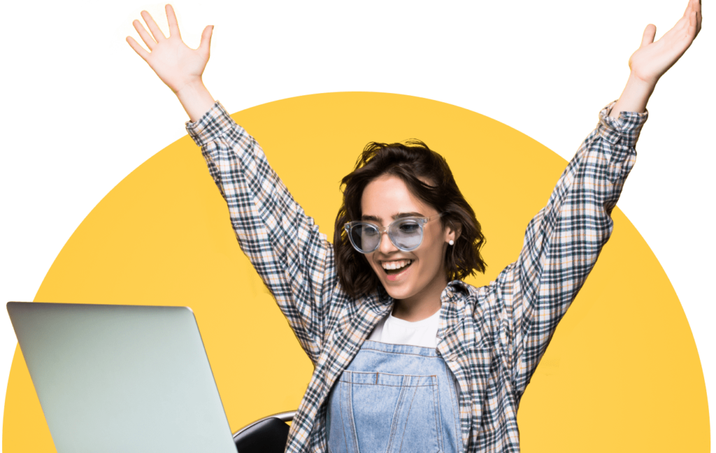 Happy Woman With Her Arms Raised Browsing Deals On A Laptop