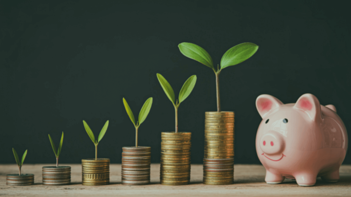 Saving money on broadband phone and TV bills with piggy bank and calculator